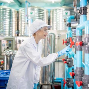 female-worker-inspecting-water-bottle-on-productio-2025-01-29-07-53-20-utc