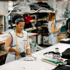 young-black-woman-labelling-finished-products-whil-2024-12-13-20-19-25-utc